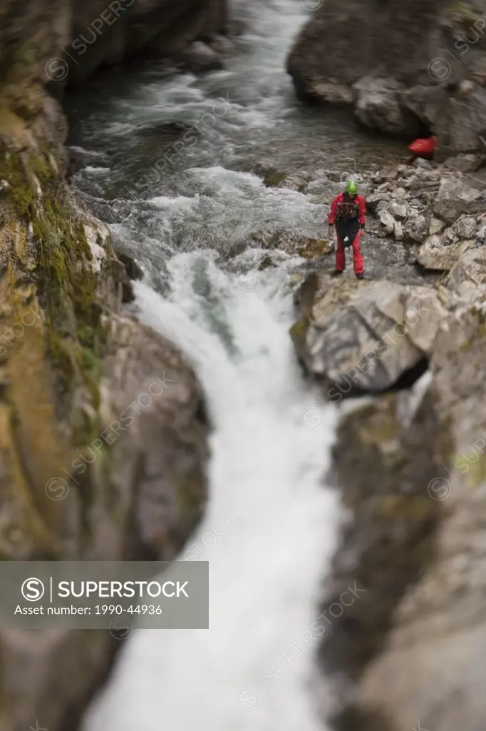 A male kayaker scoping his line off a 30 ft waterfall on Sand Creek, Galloway, British Columbia, Canada