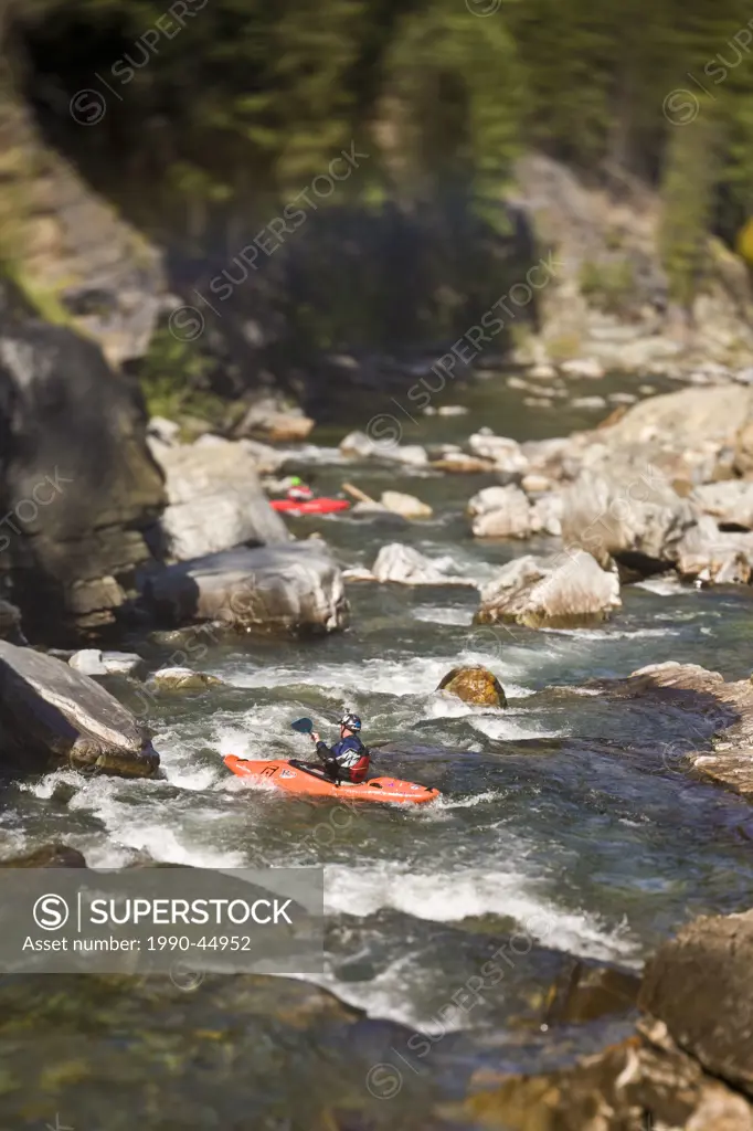 A kayaker paddles down the Moyie River, Cranbrook, British Columbia, Canada