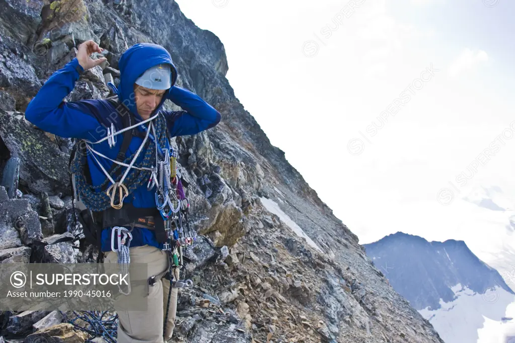 A young man mountain climbing the classic north west ridge of Mt. Sir Donald, Glacier National Park, British Columbia, Canada