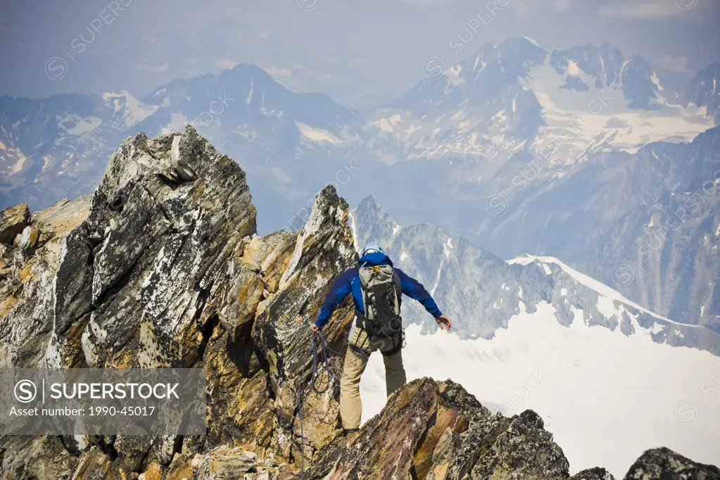 A young man mountain climbing the classic north west ridge of Mt. Sir Donald, Glacier National Park, British Columbia, Canada