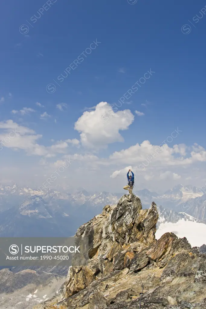 Young man mountain climbing the classic north west ridge of Mt. Sir Donald, Glacier National Park, British Columbia, Canada