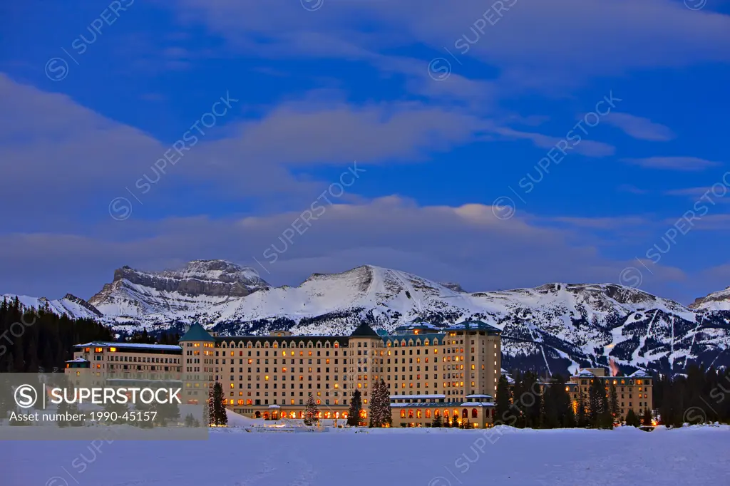 Winter landscape at the Fairmont Chateau Lake Louise on the shores of Lake Louise with the Lake Louise Ski Area in the background, Banff National Park...