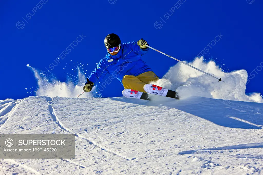 Skier on the upper slopes of Whistler Mountain, Whistler Blackcomb, Whistler, British Columbia, Canada.