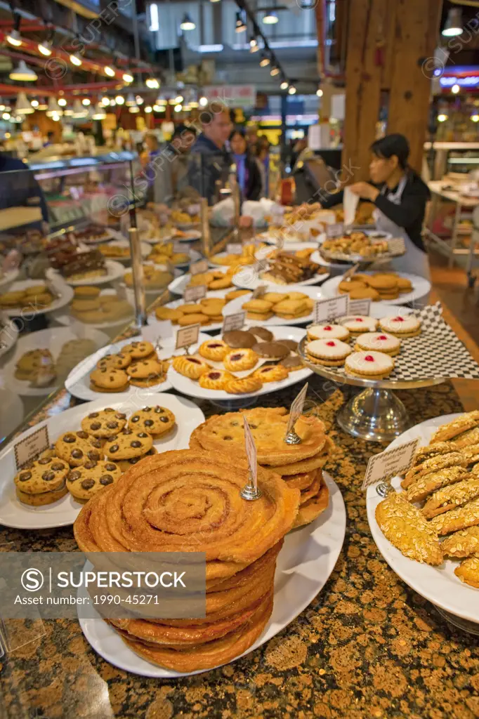 Baked goods on display at a market stall at the Granville Markets, Granville Island, Vancouver, British Columbia, Canada.