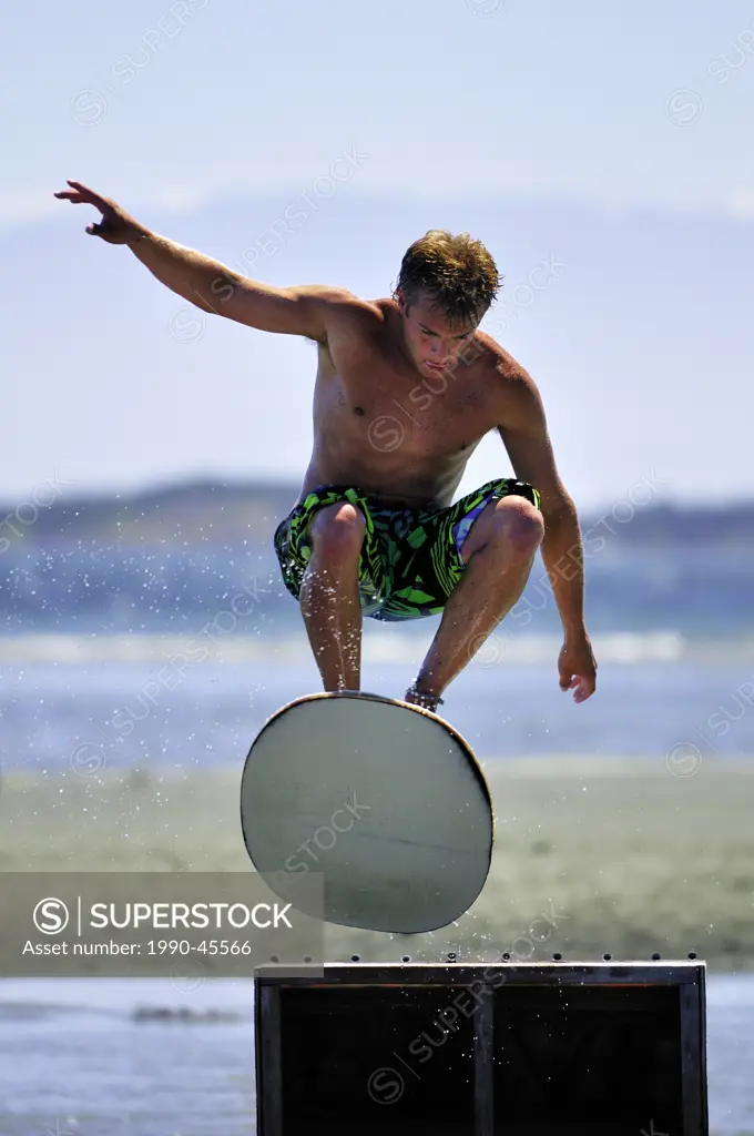 Skimboarder, gets some air at a jump during the 2010 Island Skim Session at Witty´s Lagoon Regional Park in Victoria, British Columbia, Canada.