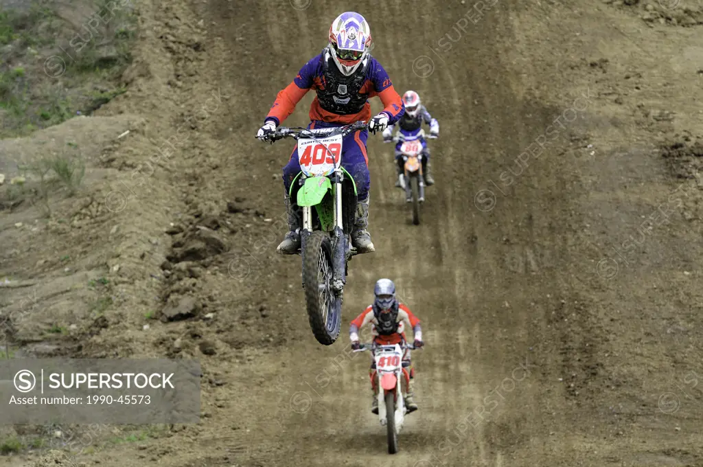 Motocross rider 409 gets airborne during a jump as he tries to stay ahead of his fellow racers at the Wastelands track in Nanaimo, British Columbia, C...