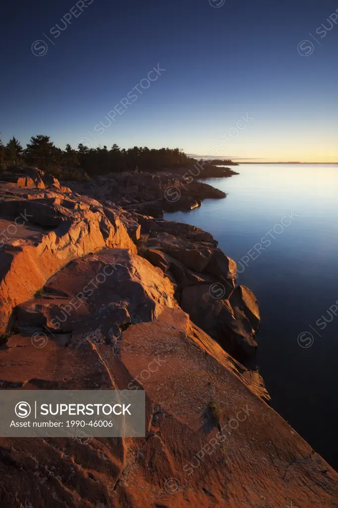 Sunrise on shore of Georgian Bay at Killarney Provincial Park, Ontario, Canada.