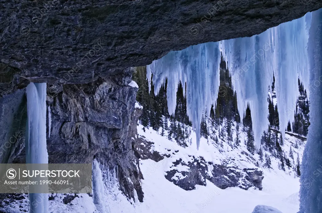 Behind the ice of frozen Panther Falls in Winter, Banff National Park, Alberta, Canada