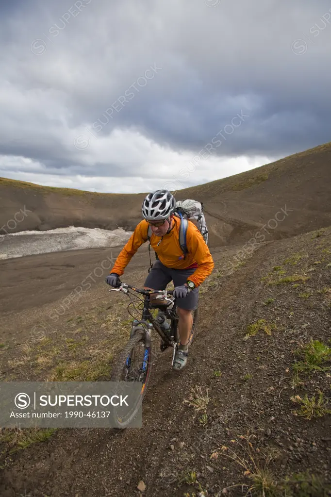 A middle aged male mountain biker rides the perfect singletrack trails of Spruce Lake Protected Area, Southern Chilcotins, British Columbia, Canada