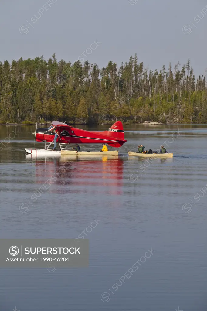 Canoeists getting picked by a float plane, Wabakimi Provincial Park, Ontario, Canada