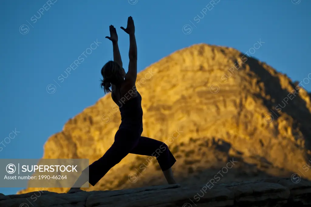 A fit young woman practicing yoga while on a rock climbing trip, Red Rocks, Las Vegas, Nevada, United States of America