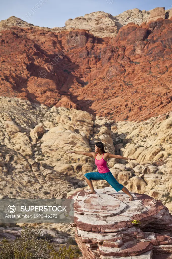 A fit young asian woman practicing yoga while on a rock climbing trip, Red Rocks, Las Vegas, Nevada, United States of America