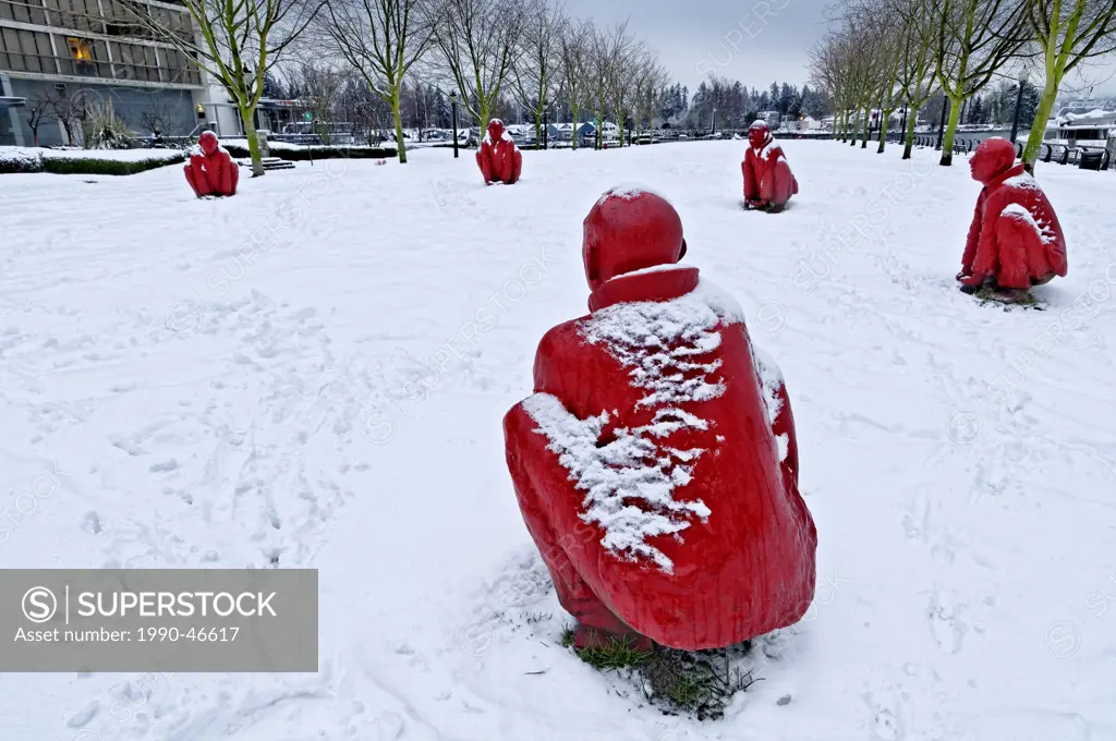 Group of red monks entitled ´The Meeting´ by sculptor Wang Shugang, in Winter, Cardero Park, Vancouver, British Columbia, Canada