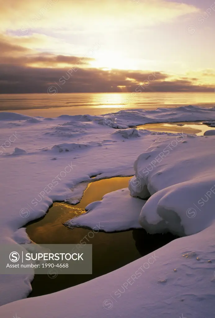 The sun rises over Georgian Bay on the Bruce Peninsula in winter, Ontario, Canada