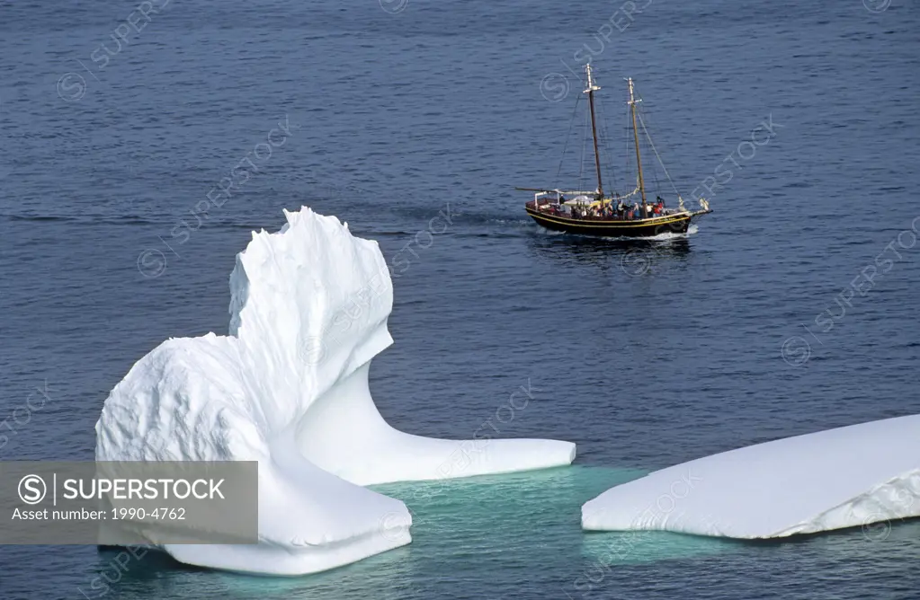 Iceberg and sailing ship off St  John´s Newfoundland, Canada
