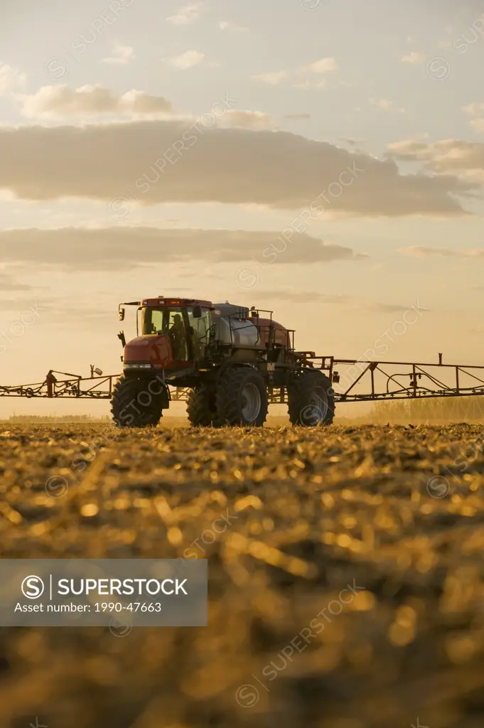 A high clearance sprayer applies liquid fertilizer on a newly seeded field, near Dugald, Manitoba, Canada