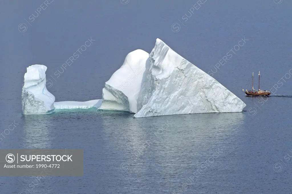 Iceberg and sailing ship off St  John´s Newfoundland, Canada