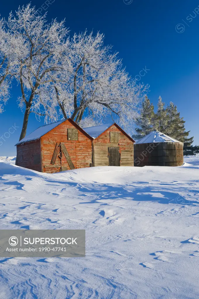 Snow drifts, old grain bins, near Estevan, Saskatchewan, Canada