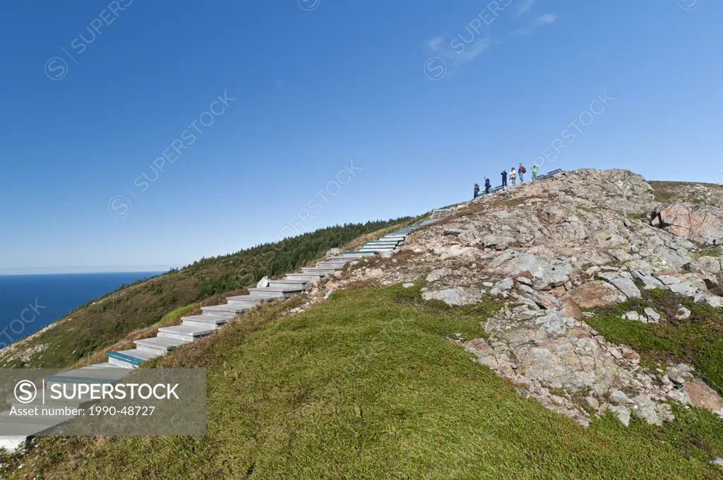 Hikers on top of Skyline Trail, Cape Breton Highlands NP, Nova Scotia, Canada. Stairway protects fragile alpine terrain. No model releases.