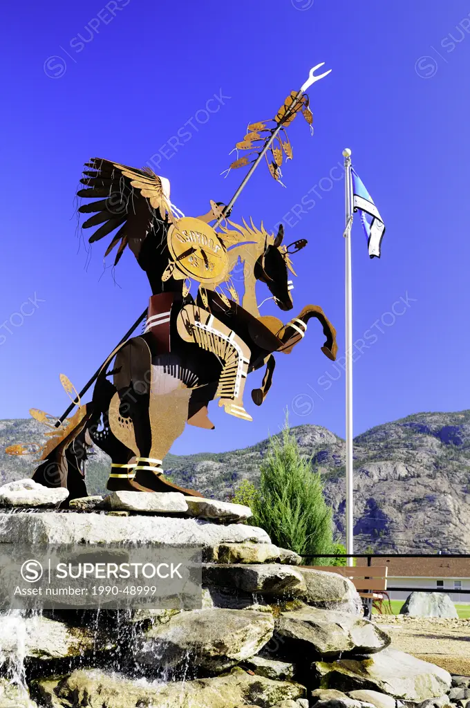 A statue of a native Indian with head dress, on a horse at the Visitor Centre in Osoyoos, British Columbia, Canada