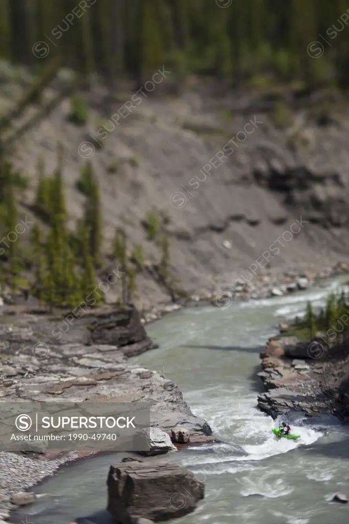 A male whitewater kayaker paddles the Big Horn River, Nordegg, Alberta, Canada