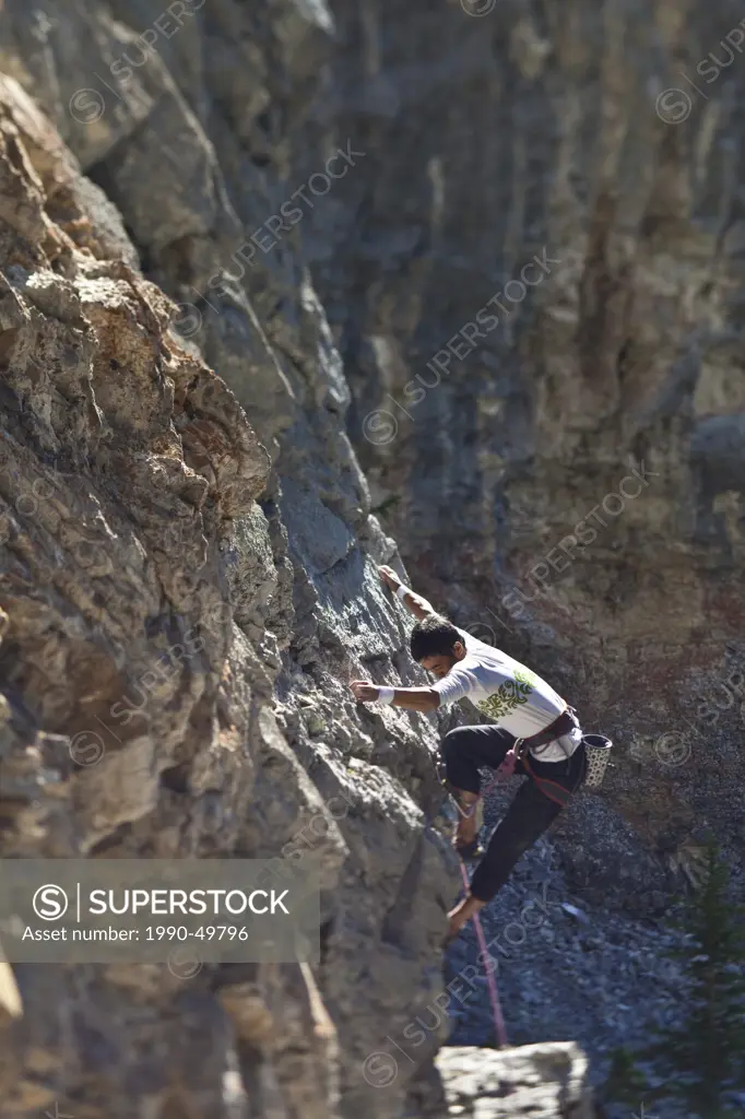 A male rockclimber climbing at Echo Canyon, Canmore, Alberta, Canada