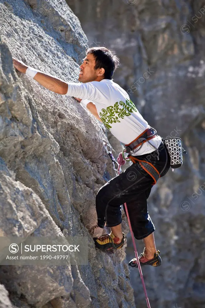 A male rockclimber climbing at Echo Canyon, Canmore, Alberta, Canada