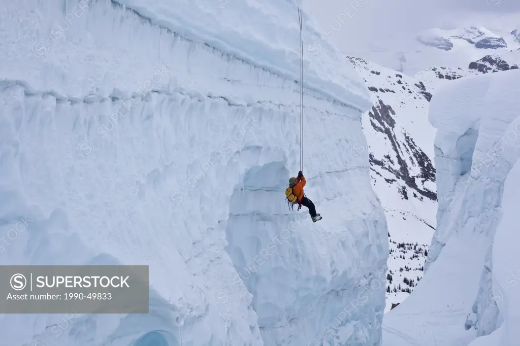 A man practicing crevasse rescue skills while on a ski mountaineering course, Ice fall Lodge, Golden, British Columbia, Canada