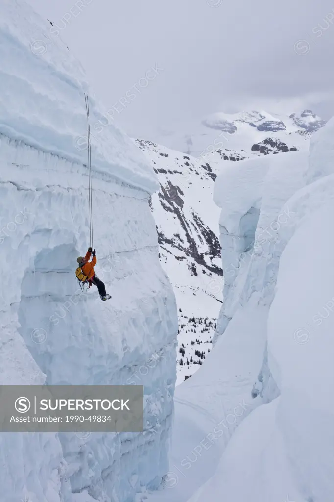 A man practicing crevasse rescue skills while on a ski mountaineering course, Ice fall Lodge, Golden, British Columbia, Canada