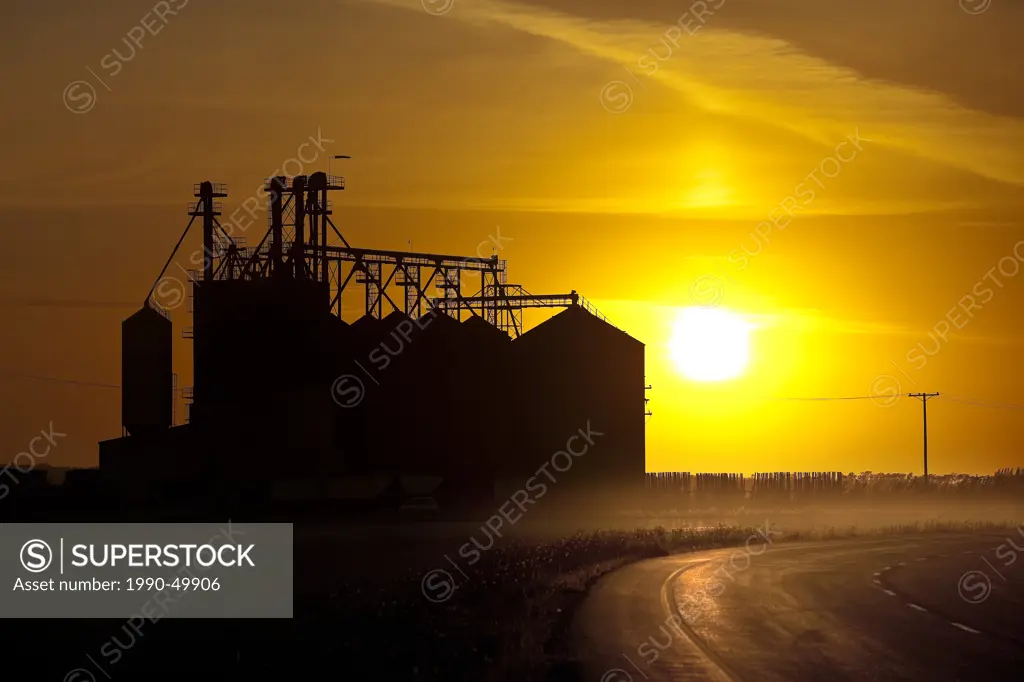 Inland Grain Terminal and Trans Canada Highway at sunset, Saskatchewan, Canada.