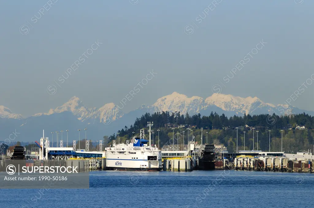 One of the many BC Ferries at berth at the Tsawwassen Ferry Terminal with the coastal mountain range in the background, Greater Vancouver Regional Dis...