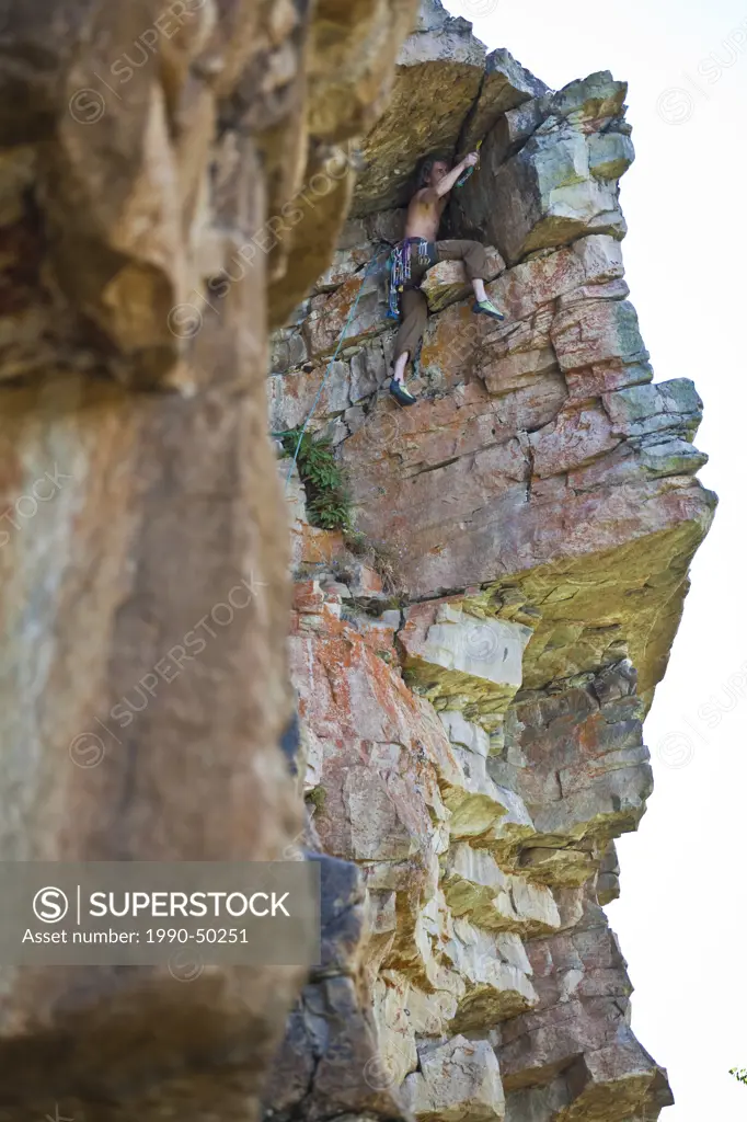 A man trad climbing a route at Lost Boys Crag, Jasper National Park, Alberta, Canada