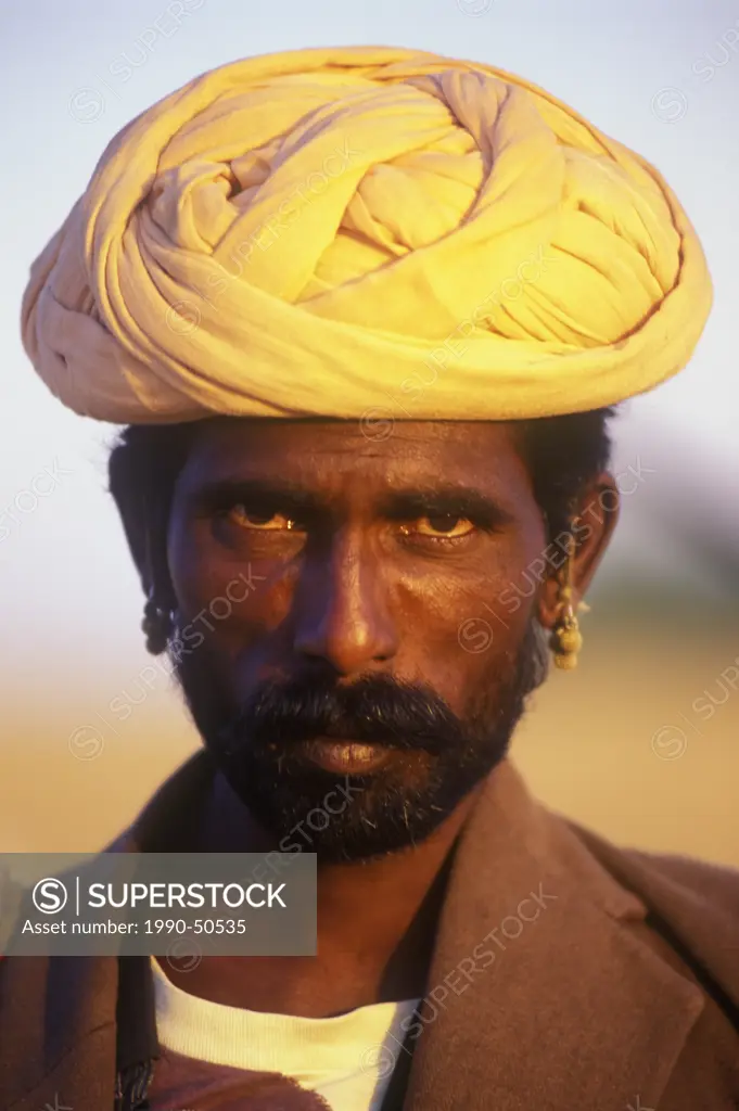 A Rajasthani man poses for the camera at the Pushkar Camel Fair in Pushkar, Rajasthan, India
