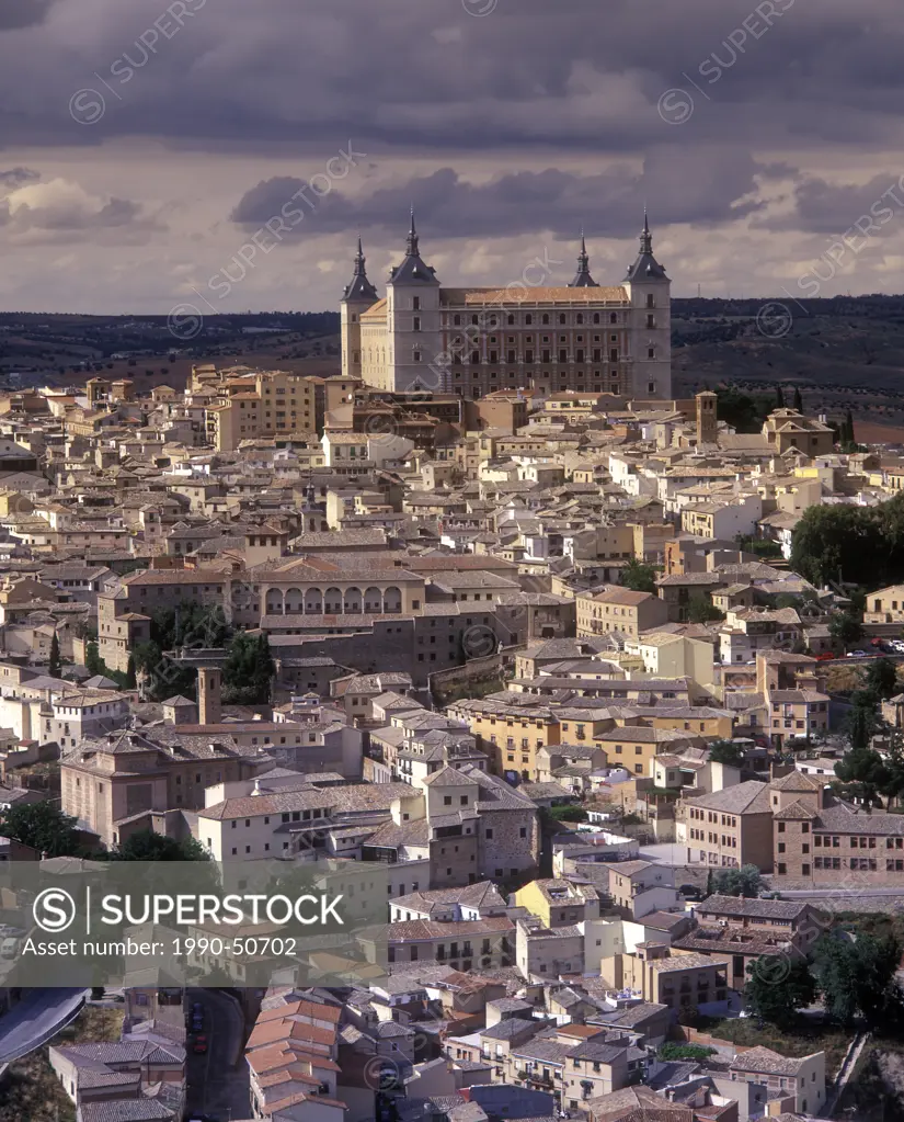 A cathedral rises from the historic walled city of Toledo, Spain