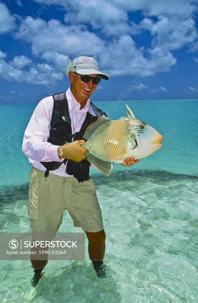 Man holding parrot fish, Seychelle Islands, Republic of Seychelles