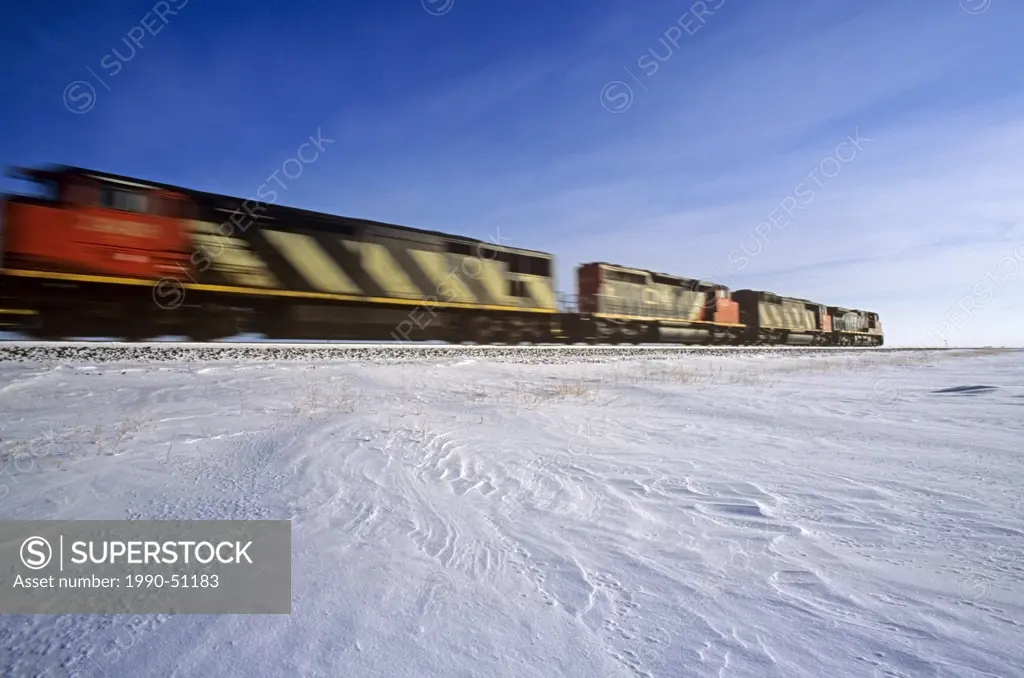 moving locomotives along a rail line during winter, near Winnipeg, Manitoba, Canada
