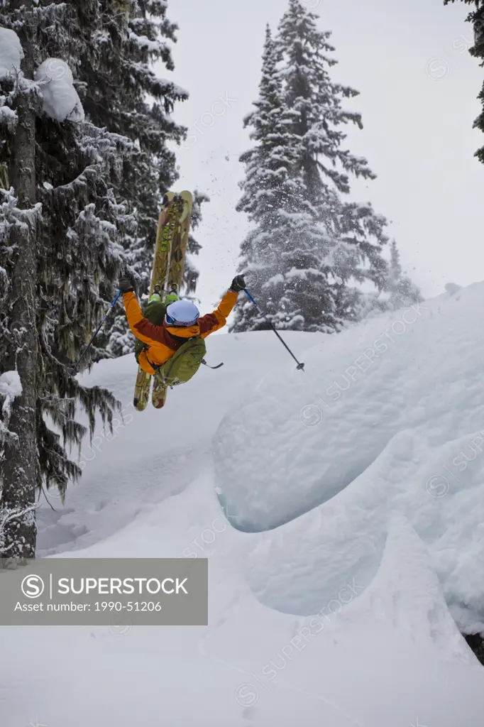 A male skier airs off a snow pillow while on a cat ski trip. Monashee Mountains, Britsh Columbia, Canada