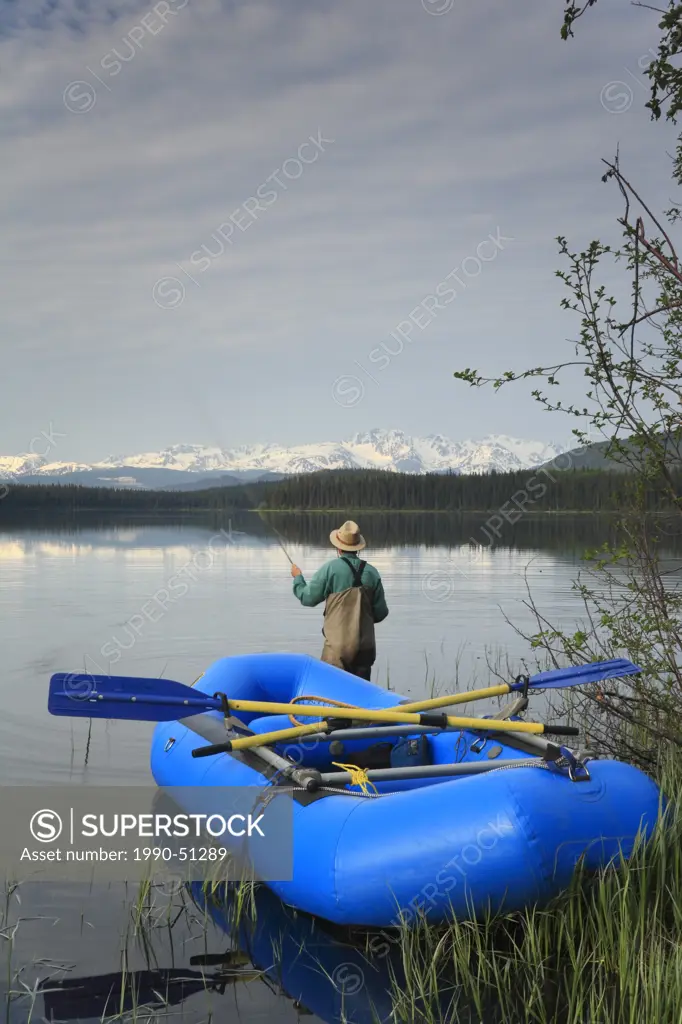 Flyfisherman trout fishing, Torkelson lake, British Columbia