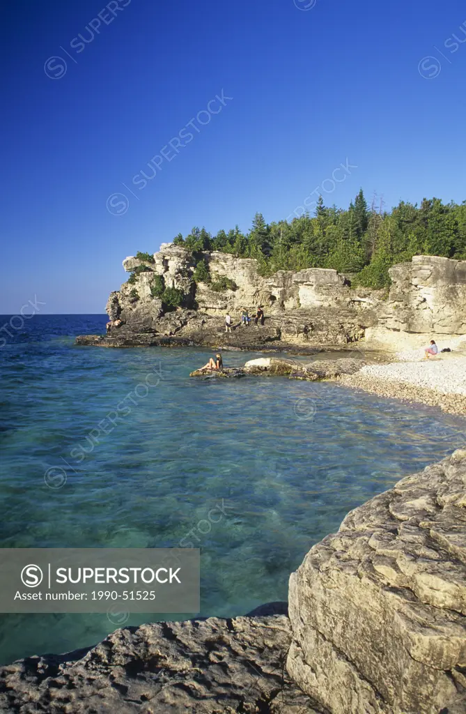 Swimmers enjoy the clear blue waters of Georgian Bay at Indian Head Cove, Bruce Peninsula National Park, Ontario, Canada.