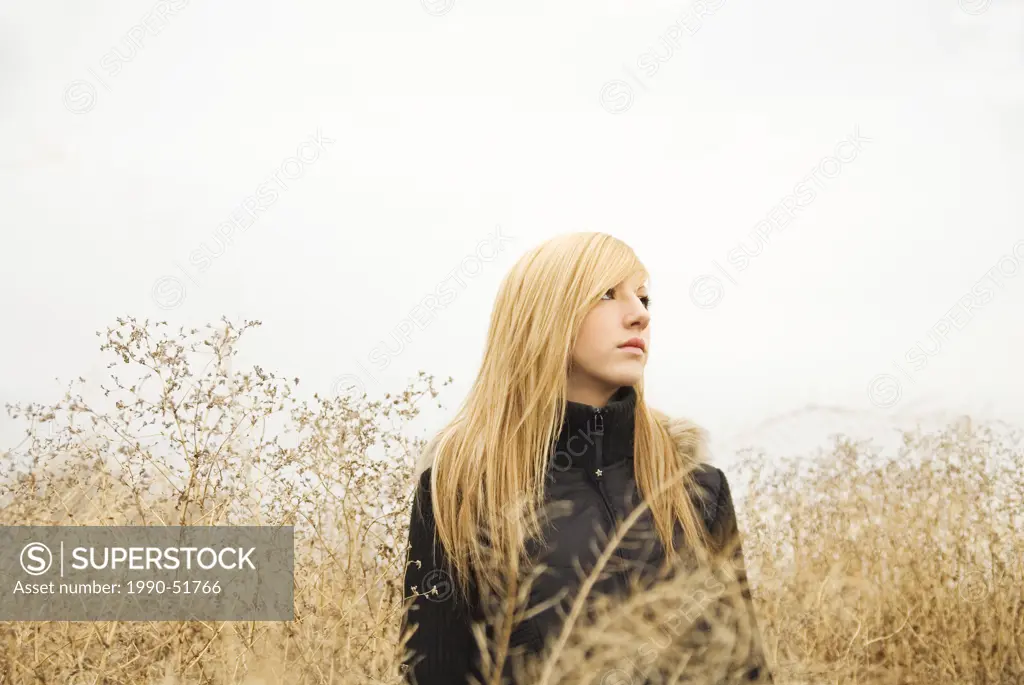 Caucasian female, in field of brush, Alberta, Canada.