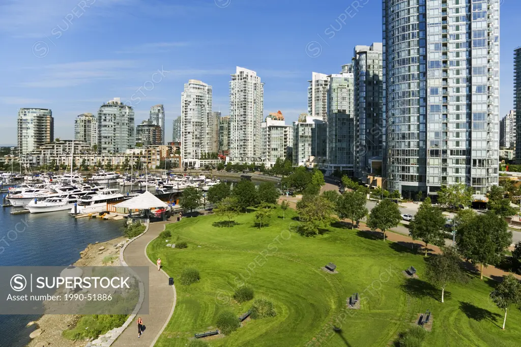 Downtown condominiums along Marinaside Crescent and Coopers Park from Cambie Bridge, Vancouver, British Columbia, Canada.