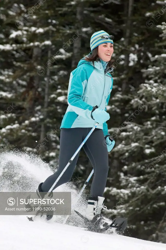 Woman snowshoeing, Lake Louise, Alberta, Canada.