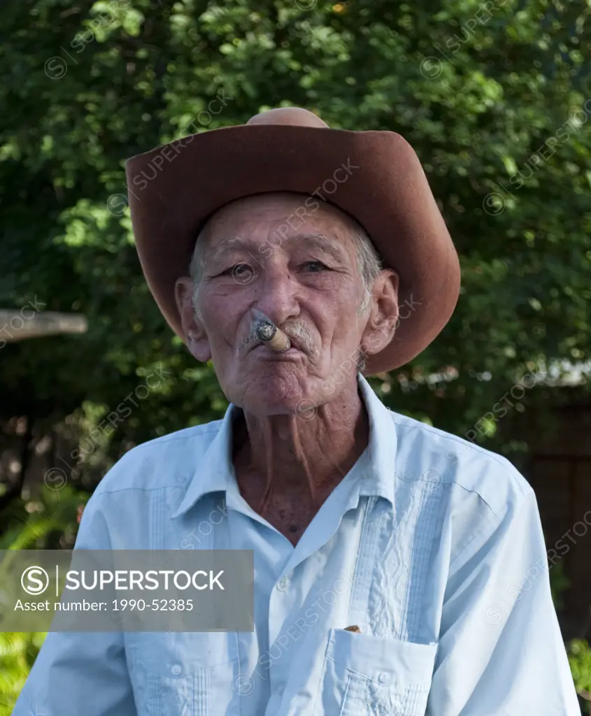 Cigar smoking man in rural area near Holguin, Cuba