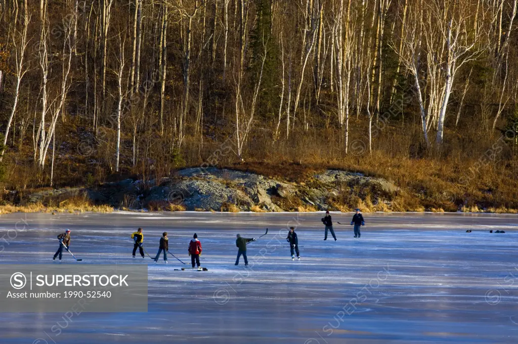 ´Shinny´ hockey game on frozen pond, Walden, Ontario, Canada.