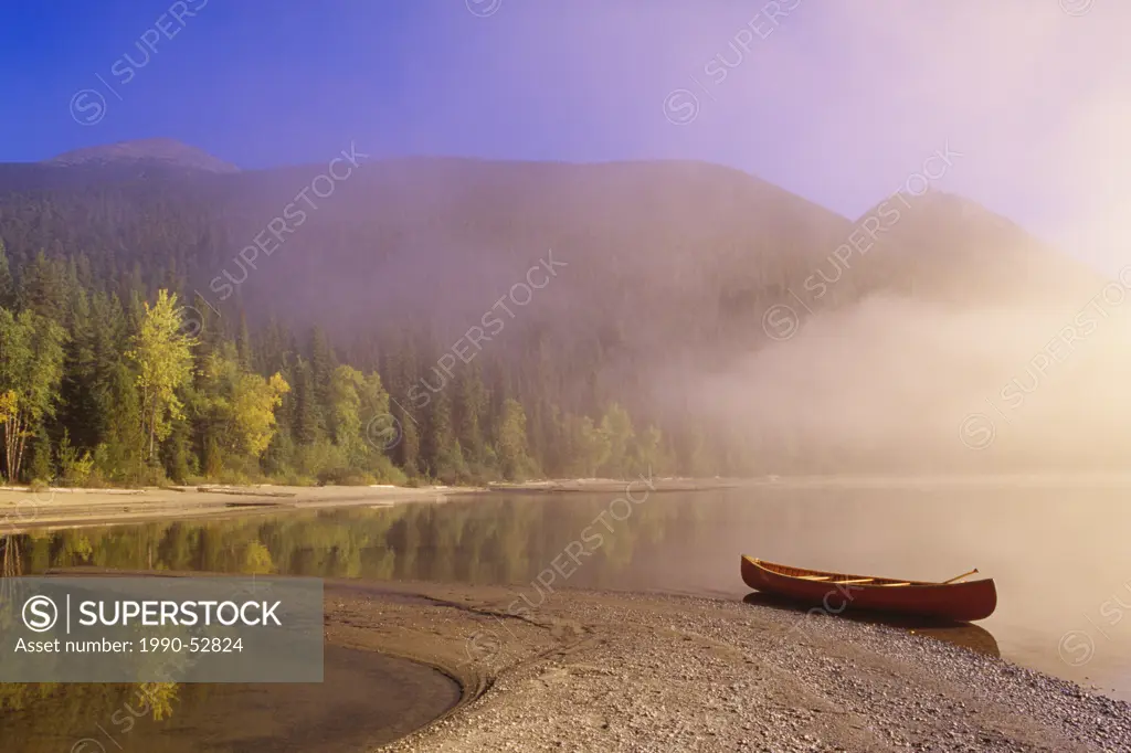 Canoe in mist, Bowron Lake Provincial Park, British Columbia, Canada.