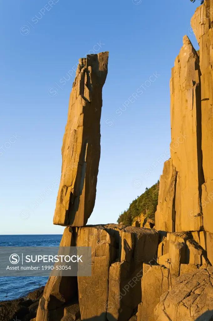 The Balancing Rock of Long Island, Nova Scotia, Canada near the Bay of Fundy is made of Jurassic basalt lava that cooled to form this vertical polygon...