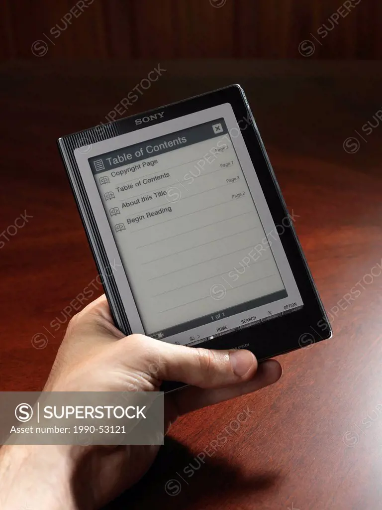 Person holding Touchchscreen e_book device, Sony PRS_700 reader