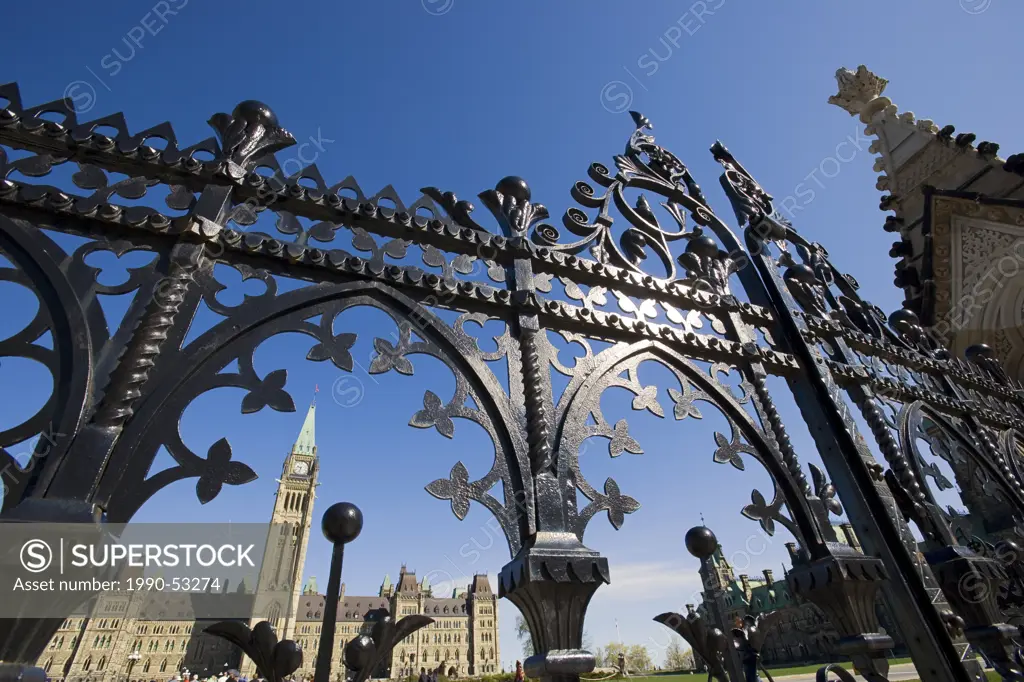 The Peace Tower and the Centre Block of the Parliament Buildings seen through the front gates. Parliament Hill, Ottawa, Ontario, Canada.