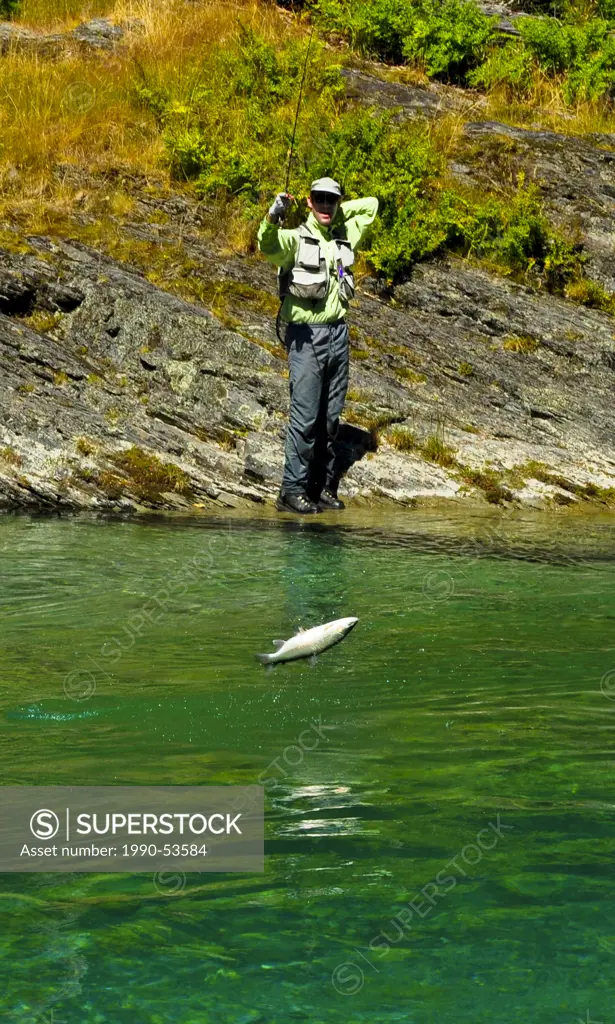 Man catching brown trout, South Island, New Zealand