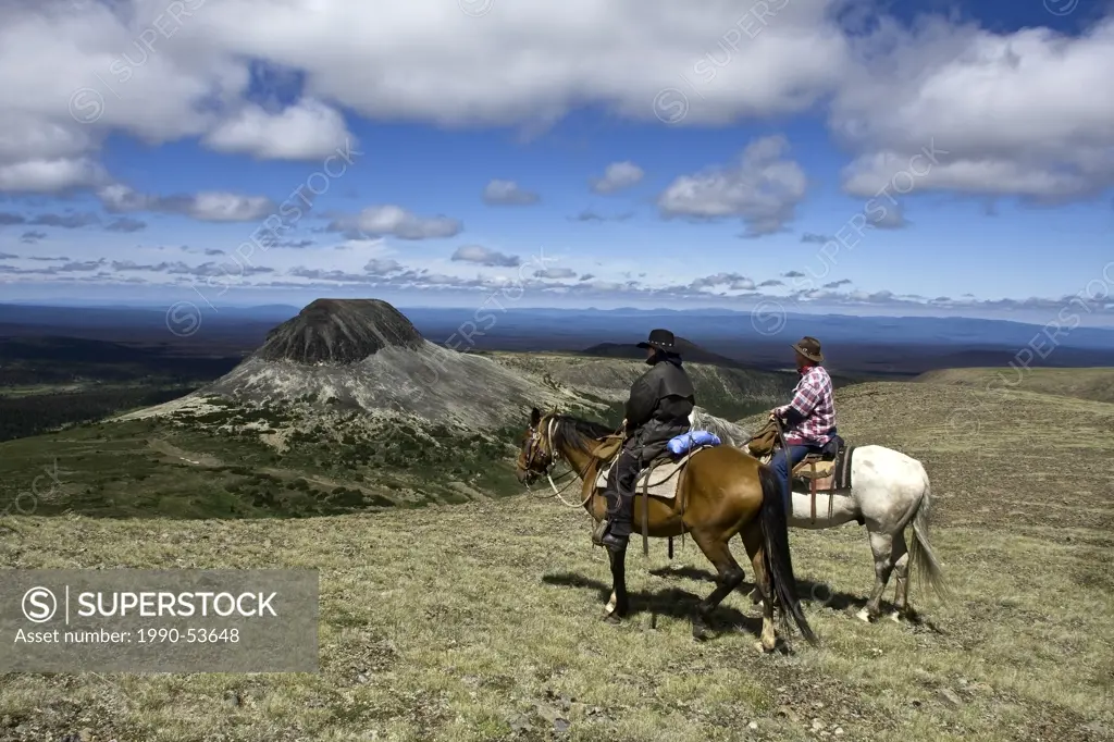Trail riders traveling through the Itcha Mountains on horse in British Columbia Canada
